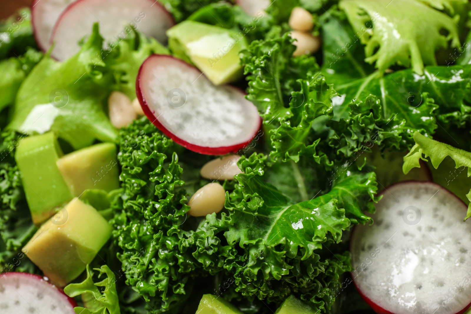 Photo of Delicious salad with kale leaves as background, closeup