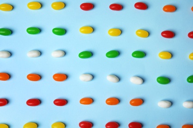 Photo of Flat lay composition with jelly beans on color background