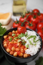 Photo of Delicious chickpea curry with rice in bowl on table, closeup