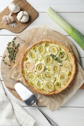 Flat lay composition with tasty leek pie and products on white wooden table