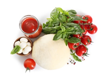 Fresh dough and ingredients for pizza on white background, top view