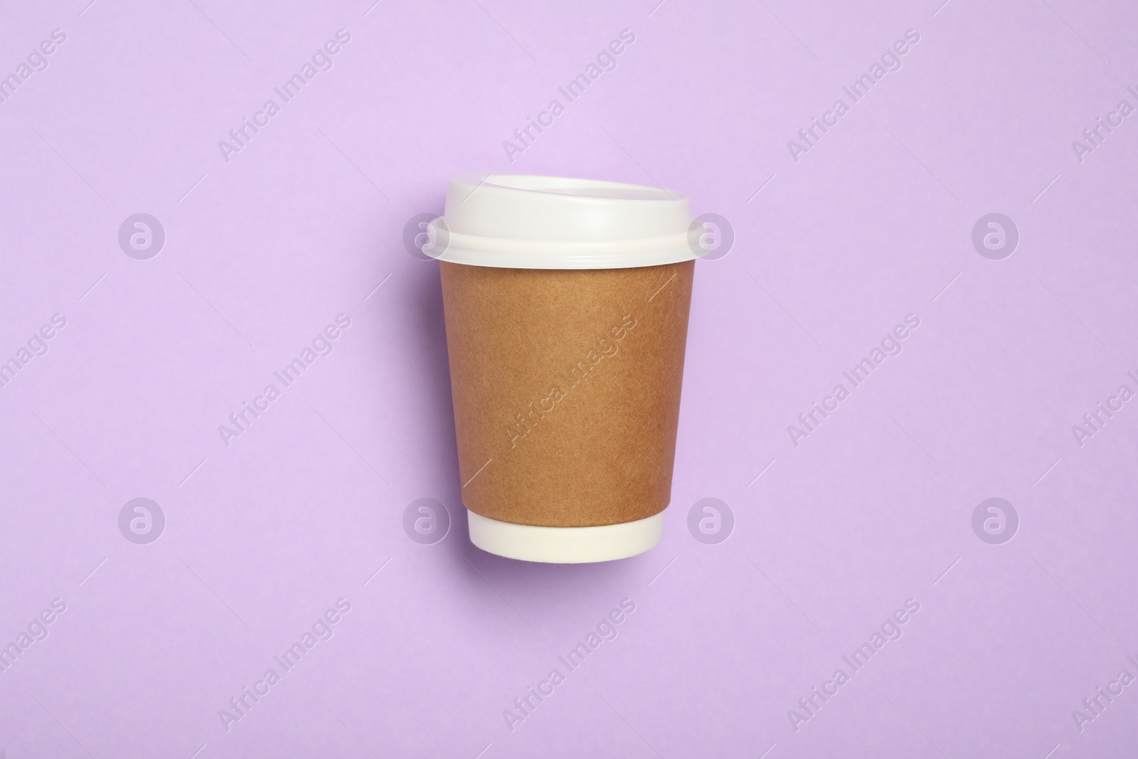 Photo of Takeaway paper coffee cup on violet background, top view