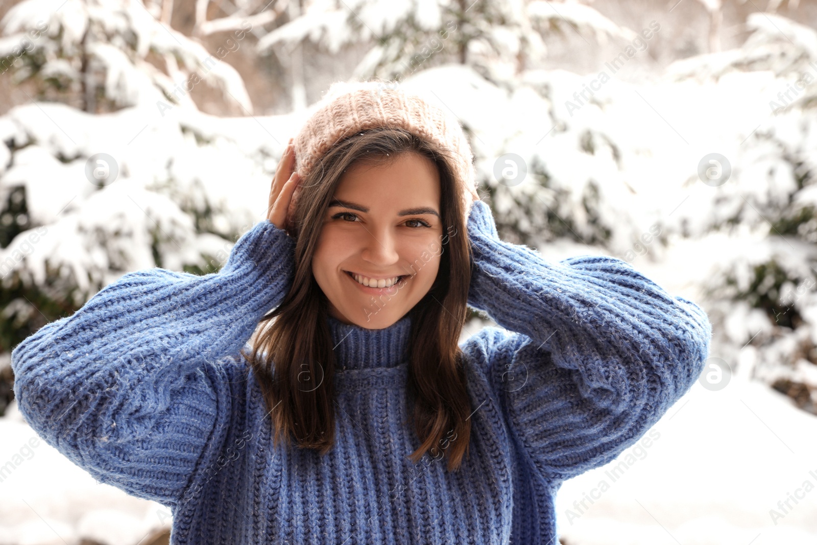 Photo of Pretty woman in warm sweater outdoors on winter day