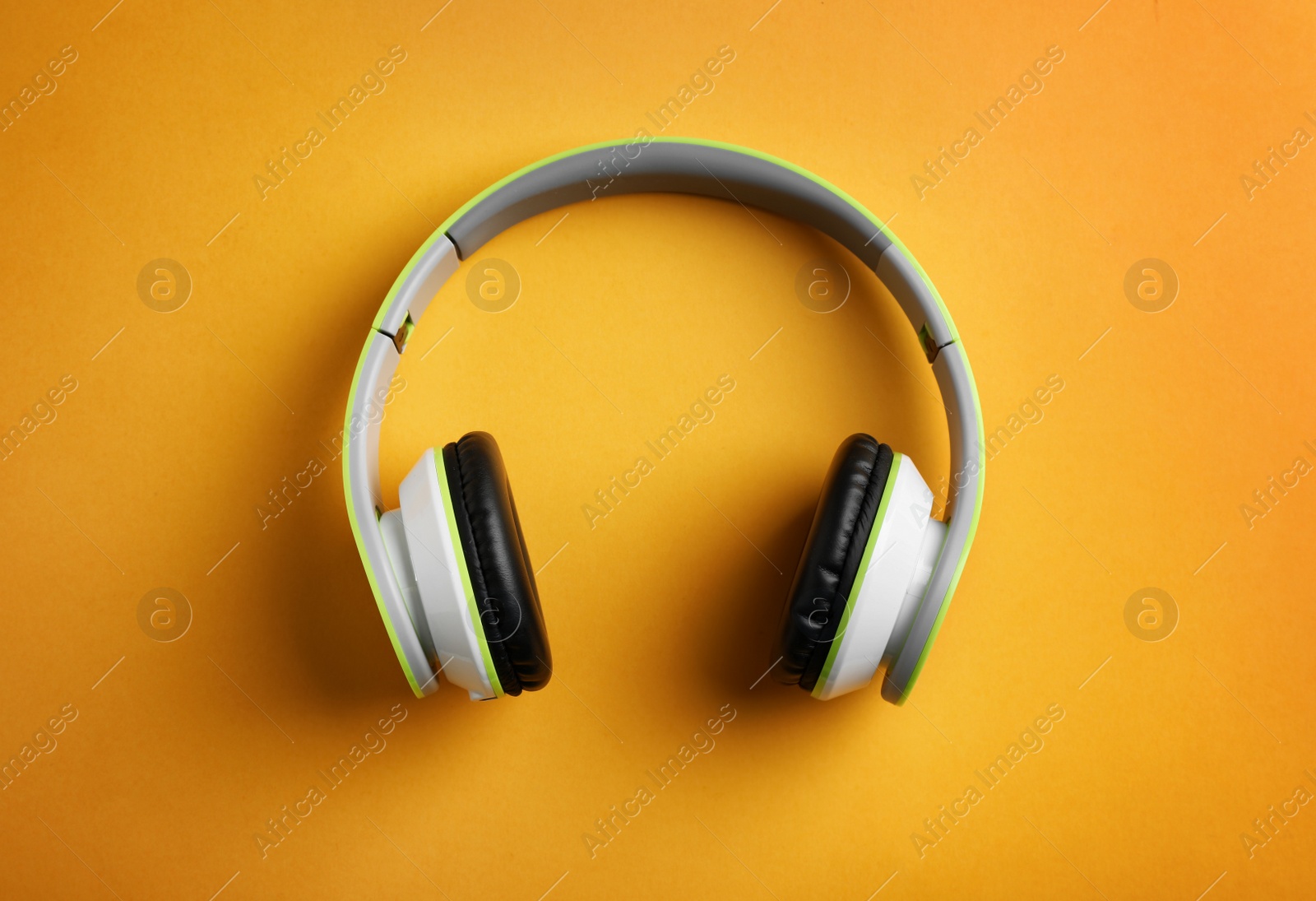 Photo of Wireless headphones on color background, top view