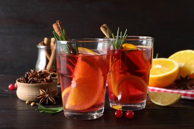 Photo of Aromatic punch drink and ingredients on wooden table