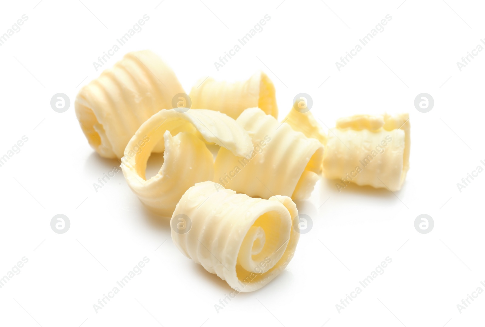 Photo of Fresh butter curls on white background