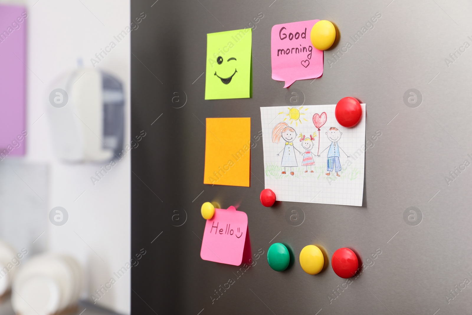 Photo of Paper sheets, child's drawing and magnets on refrigerator door indoors