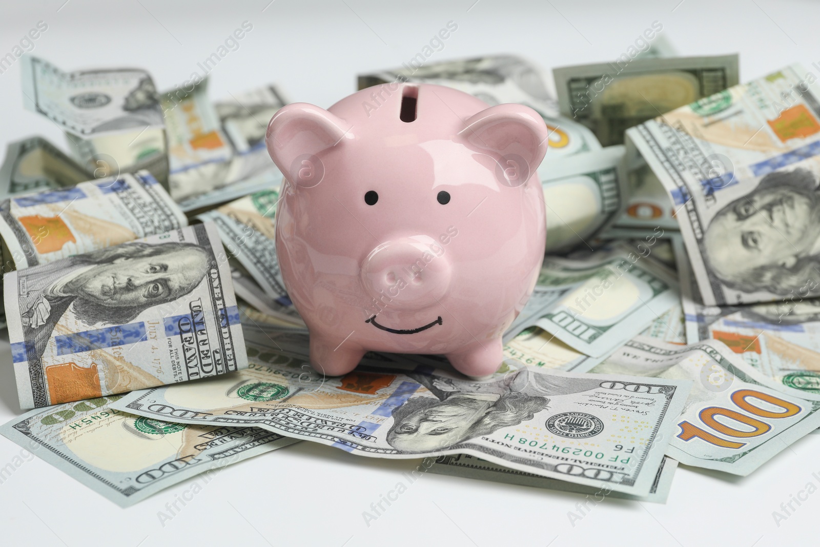 Photo of Money exchange. Dollar banknotes and piggy bank on white background, closeup