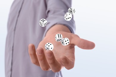 Image of Man throwing dice on white background, closeup