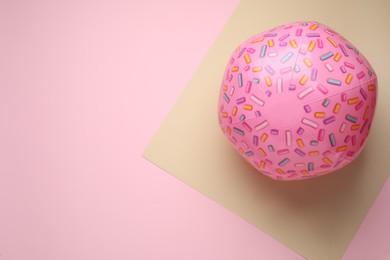 Photo of Pink beach ball on color background, top view. Space for text