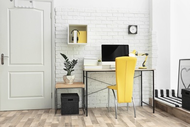 Photo of Comfortable workplace with computer on desk in home office