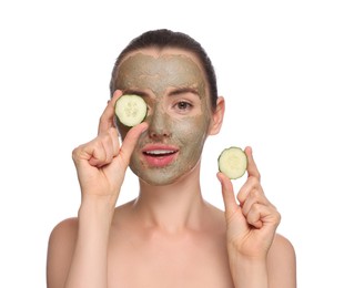 Photo of Beautiful woman with clay mask holding pieces of cucumber on white background