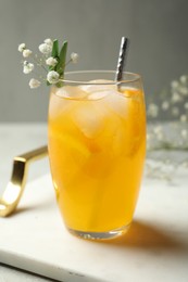 Delicious orange soda water in glass on tray