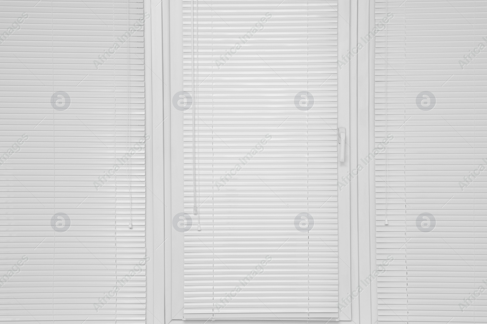 Photo of Stylish window with horizontal blinds in room