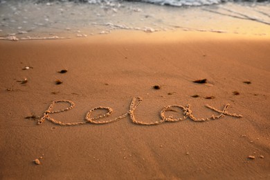 Photo of Sandy beach with written word Relax in summer