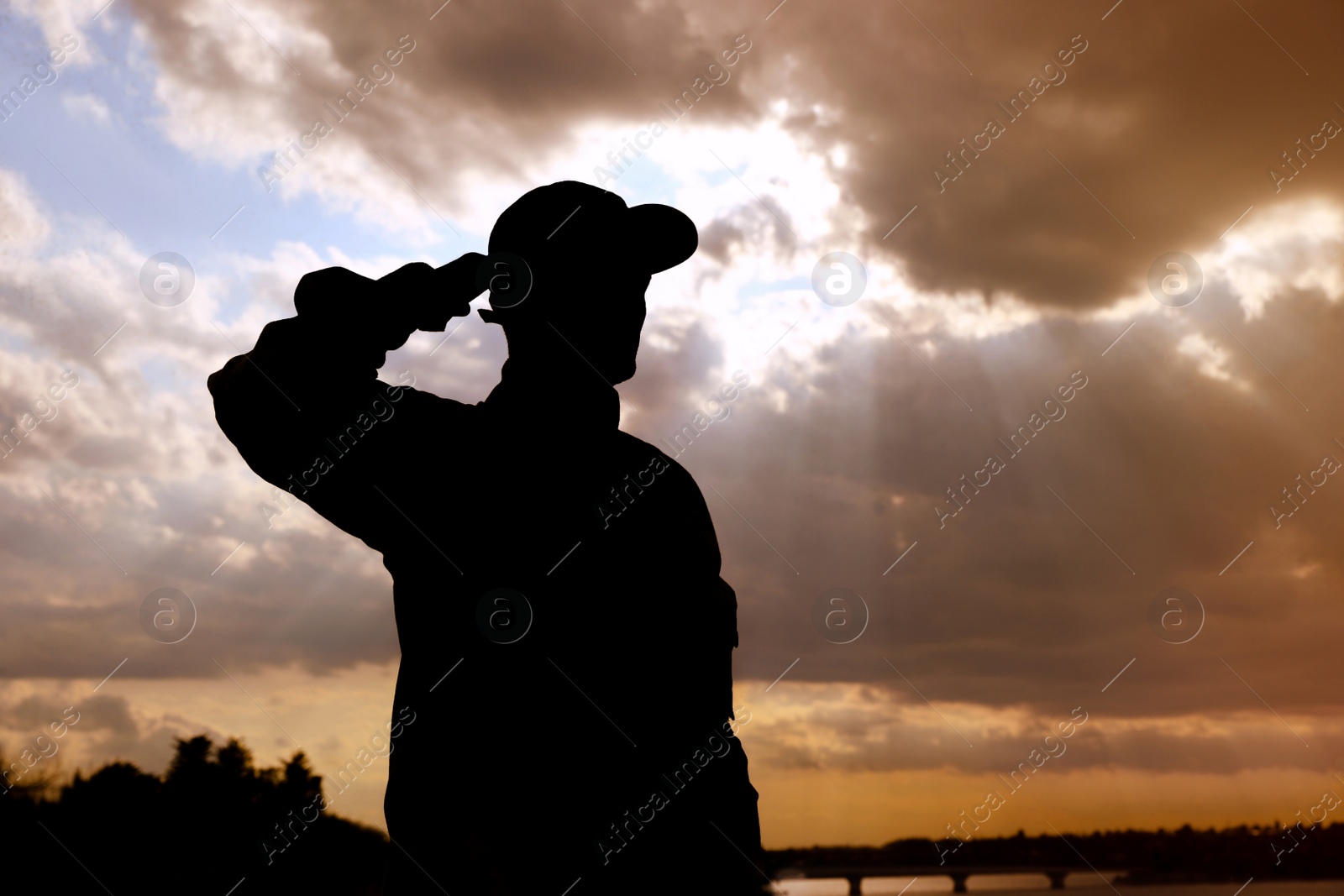 Photo of Soldier in uniform saluting outdoors. Military service