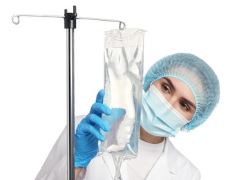 Photo of Nurse setting up IV drip on white background