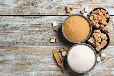 Photo of Flat lay composition with different types of sugar on rustic table, space for text