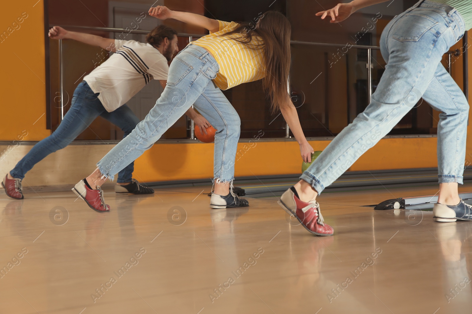 Photo of Group of friends throwing balls in bowling club