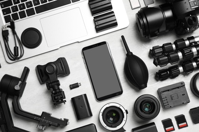 Photo of Camera and video production equipment on light background, flat lay