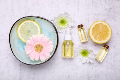 Photo of Flat lay composition with bowl of water and beautiful flowers on light table. Spa treatment