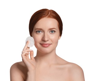 Photo of Beautiful woman with freckles holding cotton pad on white background