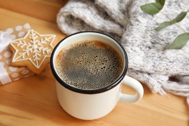 Composition with cup of hot winter drink on wooden table. Cozy season