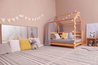 Photo of Stylish child room interior with comfortable floor bed