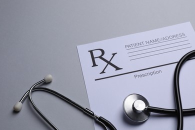 Photo of Medical prescription form and stethoscope on light grey background. Space for text