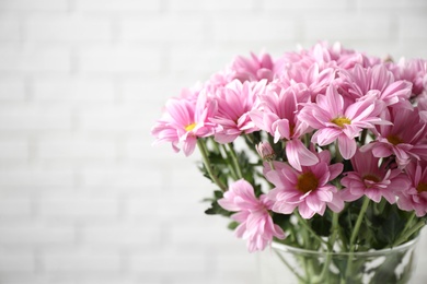 Vase with beautiful chamomile flowers on white background, closeup. Space for text