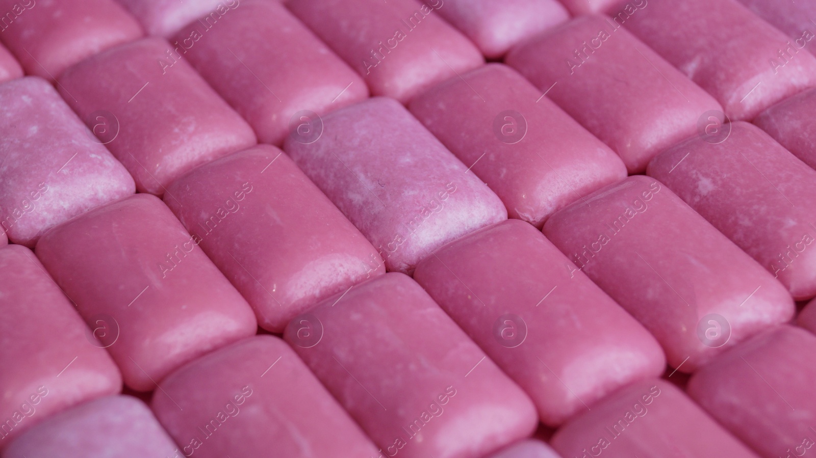 Photo of Many pink chewing gums as background, closeup