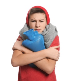 Photo of Sick teenage boy with hot water bottle on white background