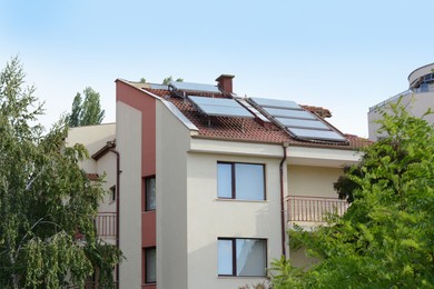 Beautiful house with solar panels on roof outdoors