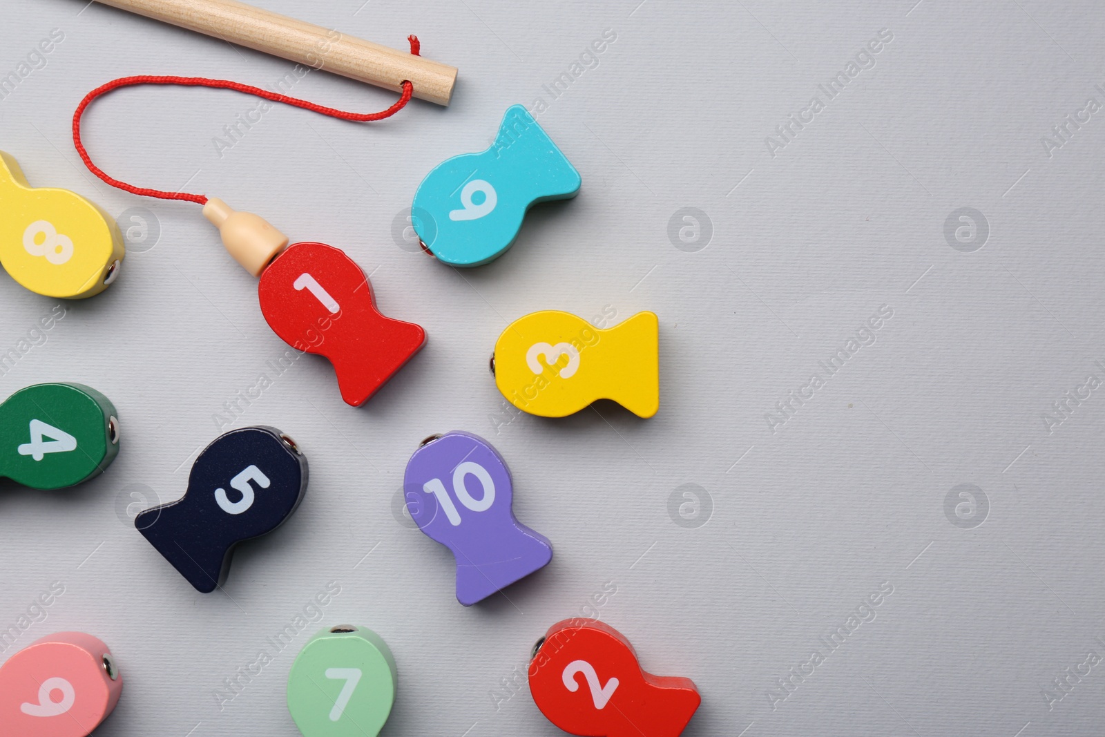 Photo of Educational game Fishing for Numbers on light grey background, flat lay. Space for text