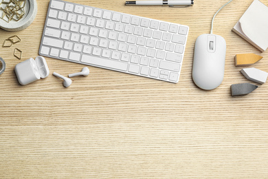 Photo of Flat lay composition with wired computer mouse and keyboard on  wooden table. Space for text