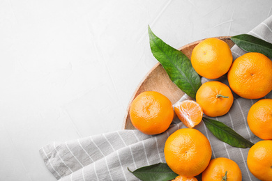 Photo of Fresh ripe tangerines on white table, flat lay. Space for text