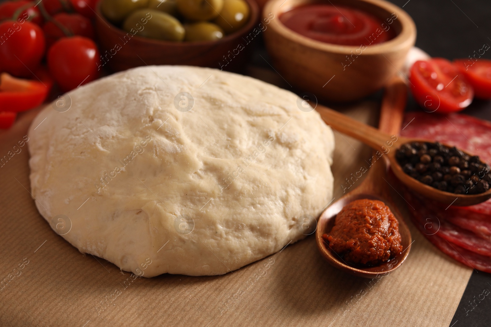 Photo of Pizza dough and products on table, closeup