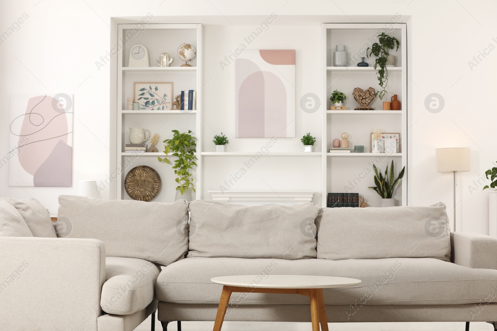 Photo of Stylish living room interior with comfortable sofa and side table