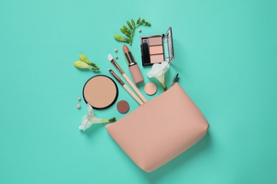Flat lay composition with different makeup products and beautiful flowers on turquoise background