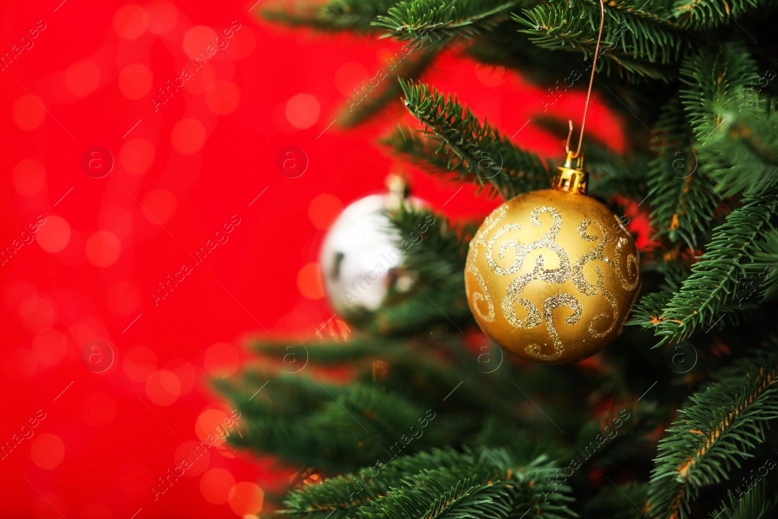 Photo of Decorated fir tree against blurred Christmas lights