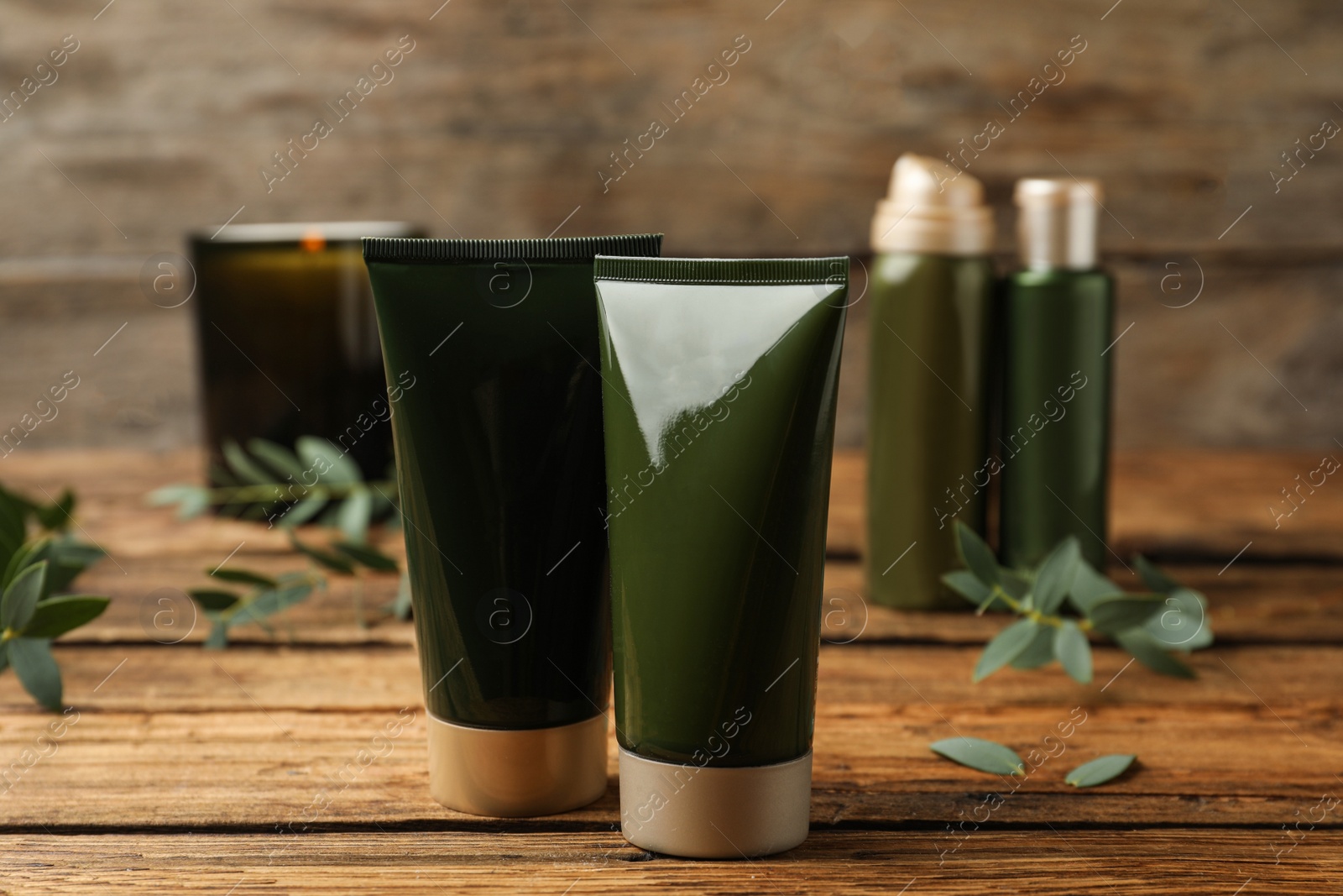 Photo of Different cosmetic products on wooden table, closeup