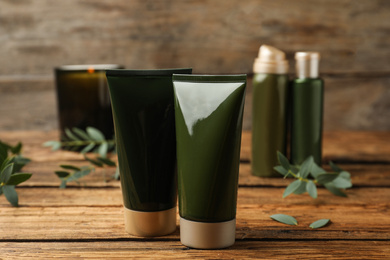 Different cosmetic products on wooden table, closeup