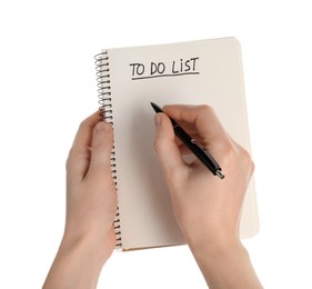 Photo of Woman filling To Do list in notepad on white background, closeup