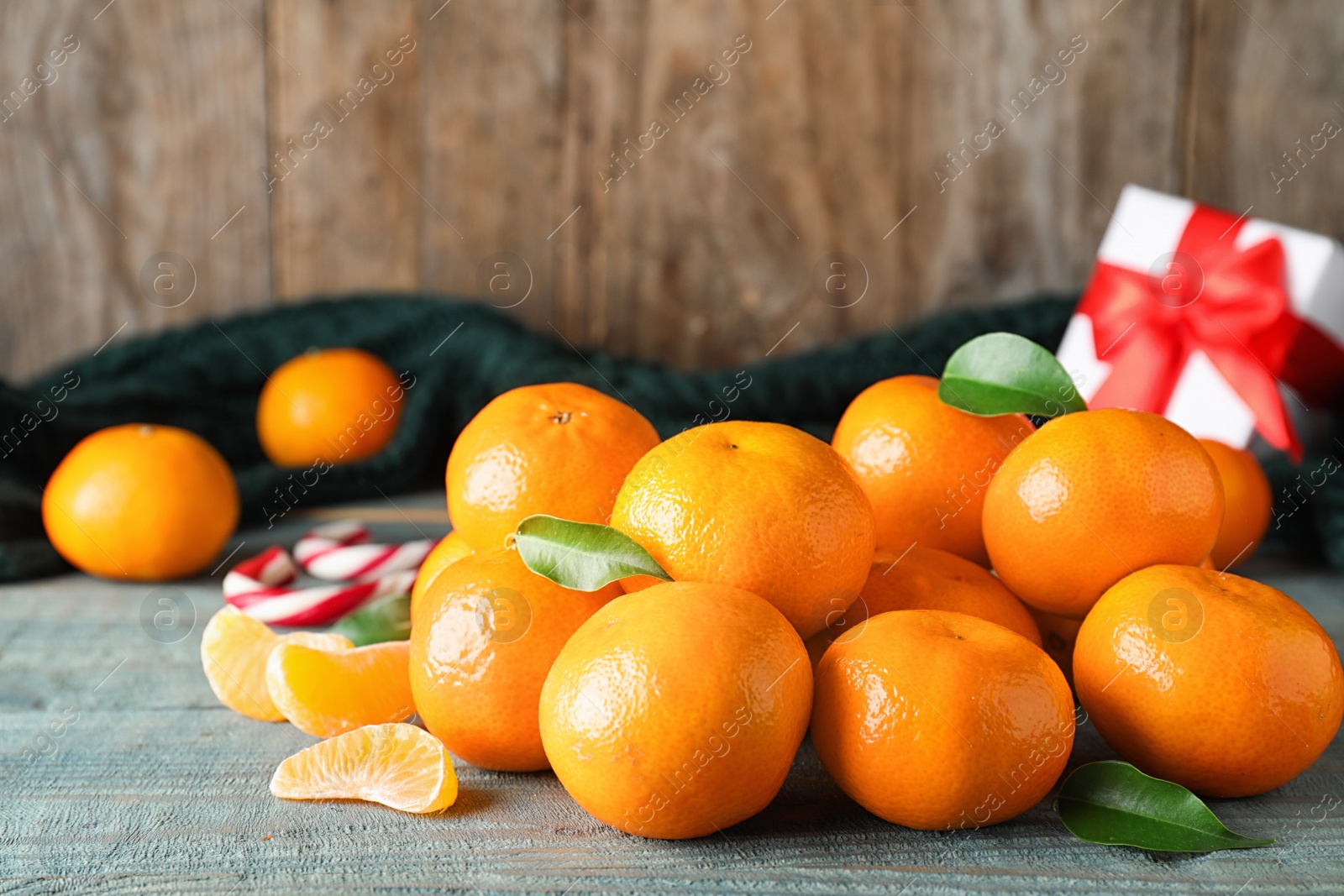 Photo of Tasty fresh tangerines on blue wooden table. Christmas celebration