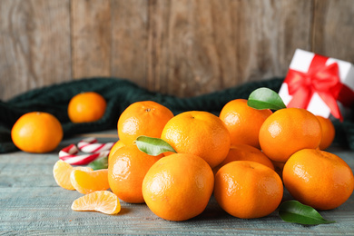 Tasty fresh tangerines on blue wooden table. Christmas celebration