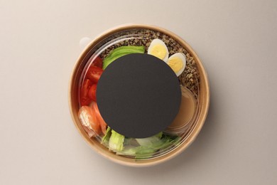 Tasty food in container on light background, top view. Space for text