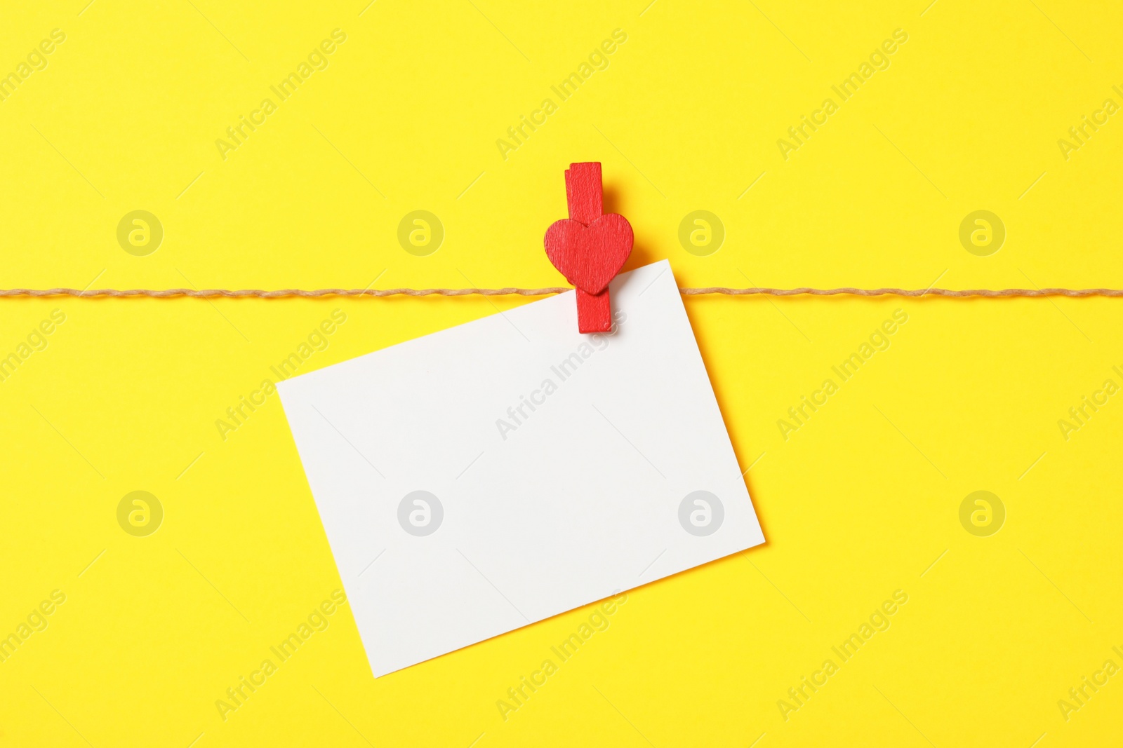 Photo of Blank card on yellow background, top view with space for text. Valentine's Day celebration