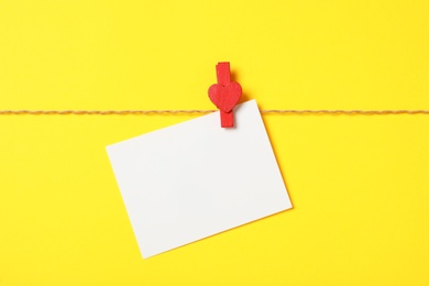 Photo of Blank card on yellow background, top view with space for text. Valentine's Day celebration