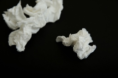 Photo of Used white paper tissues on black background