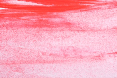 Abstract brushstrokes of bright red paint as background